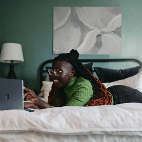 woman relaxing in bed on laptop with coffee | meal support coaching program in california online therapy | body image issues | eating disorder treatment | Orange County 92806 | San Francisco 94188| Pasadena 91199